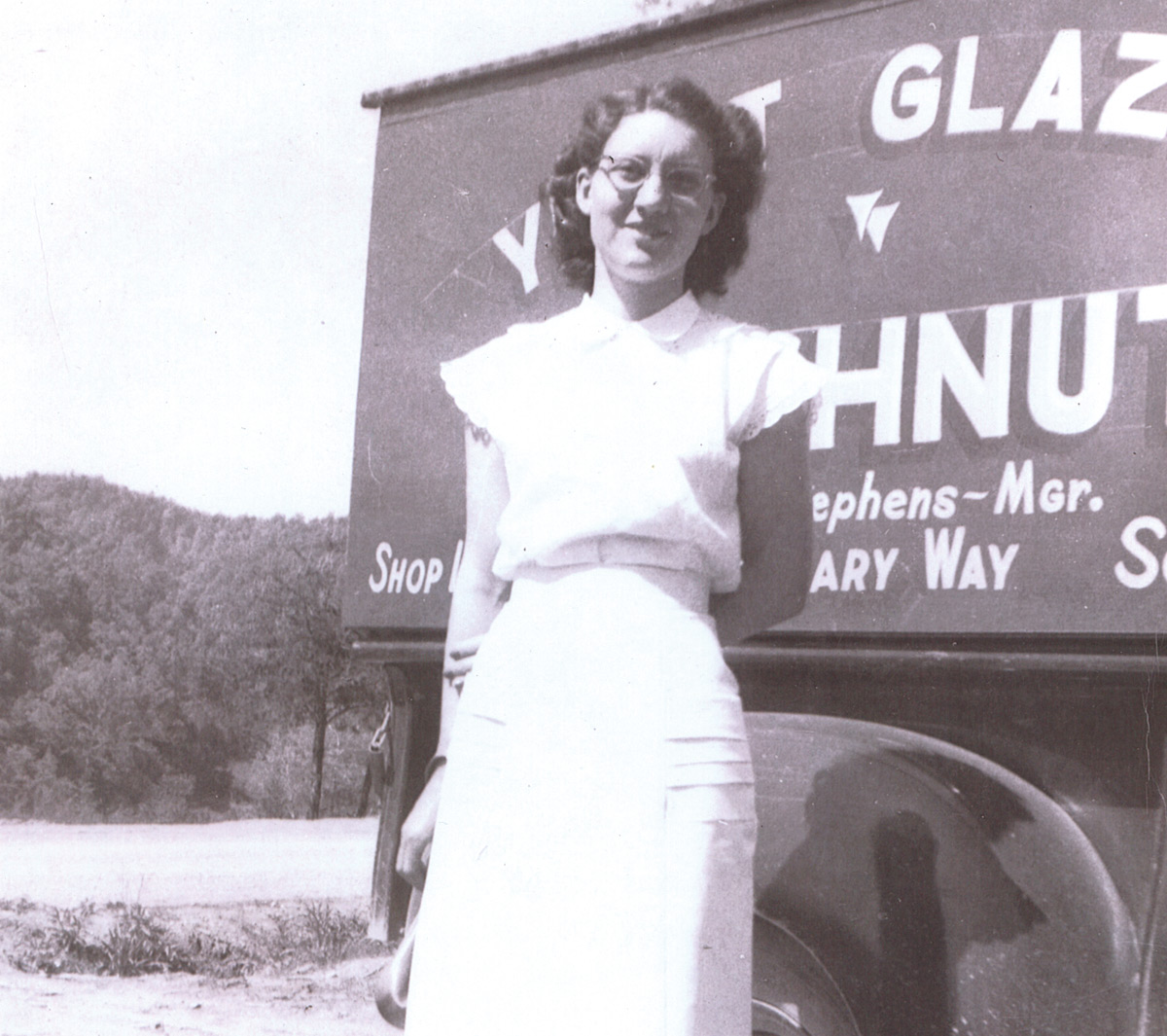 Old photograph of Rosemary Stephens in front of a delivery van
